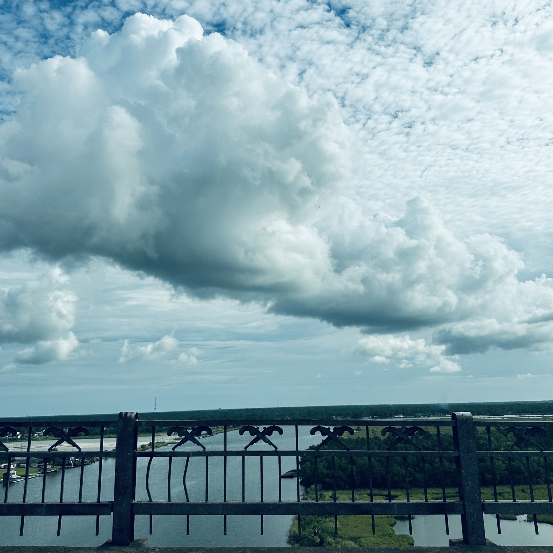 View driving over the bridge with clouds.