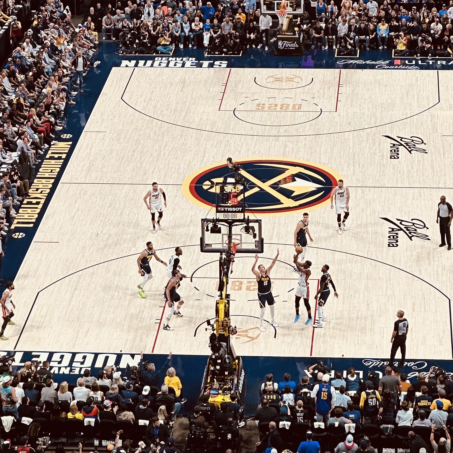Basketball court in Denver. Butler shooting over Nokic.