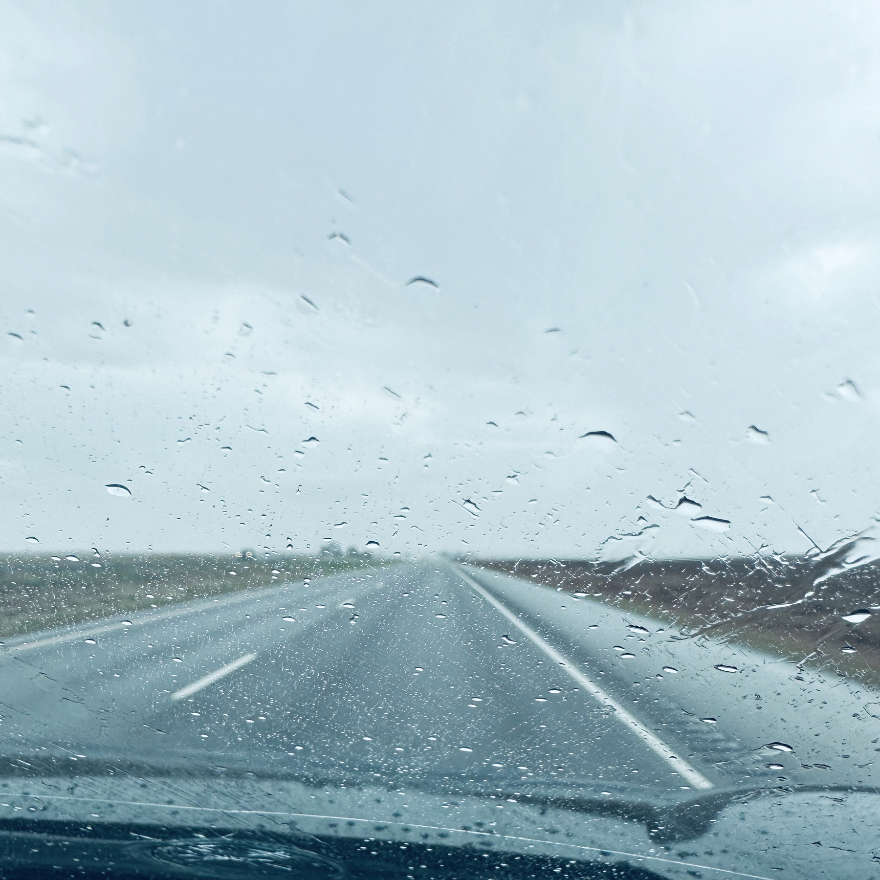Highway with rain on car window.