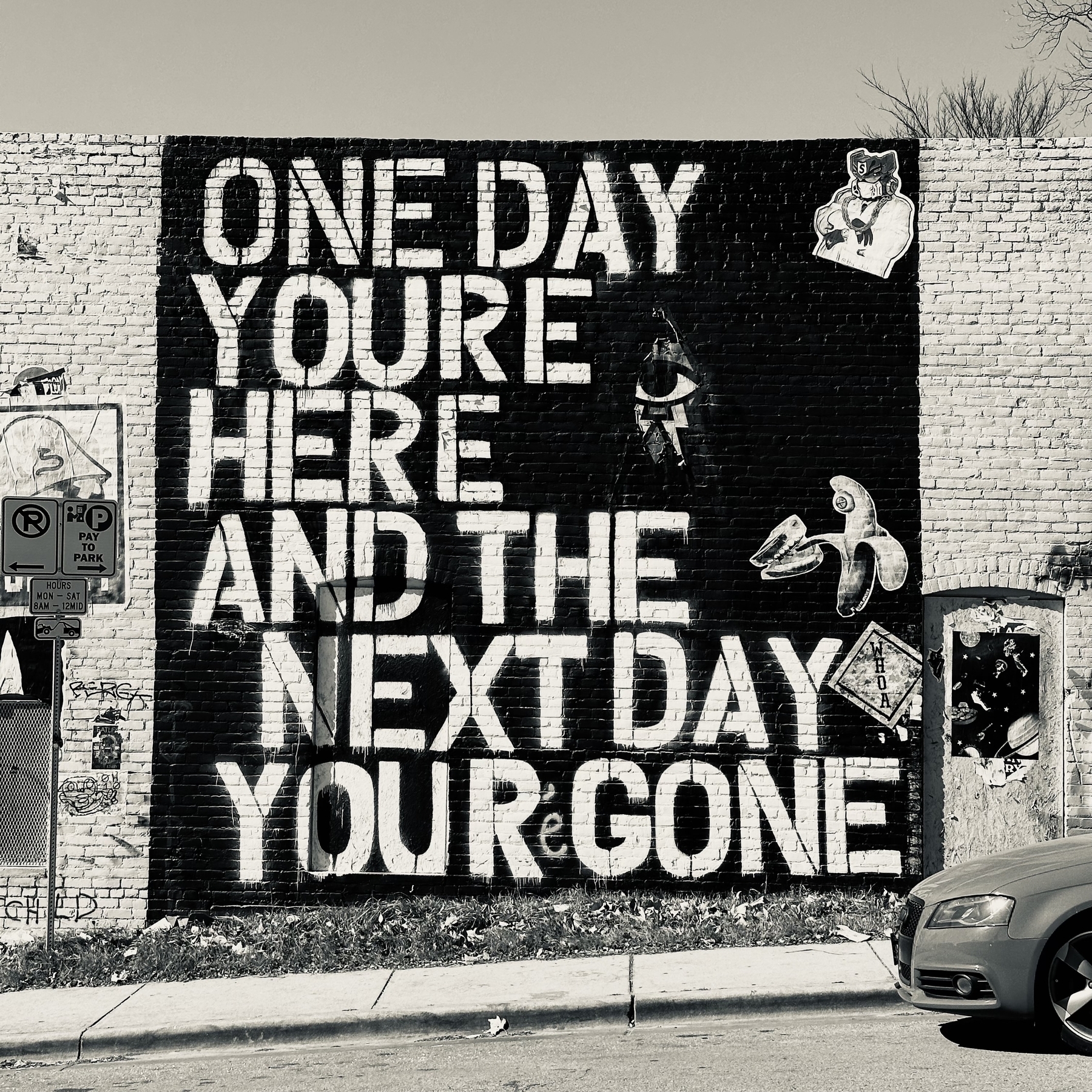 Mural that says one day you’re here and the next day your gone.