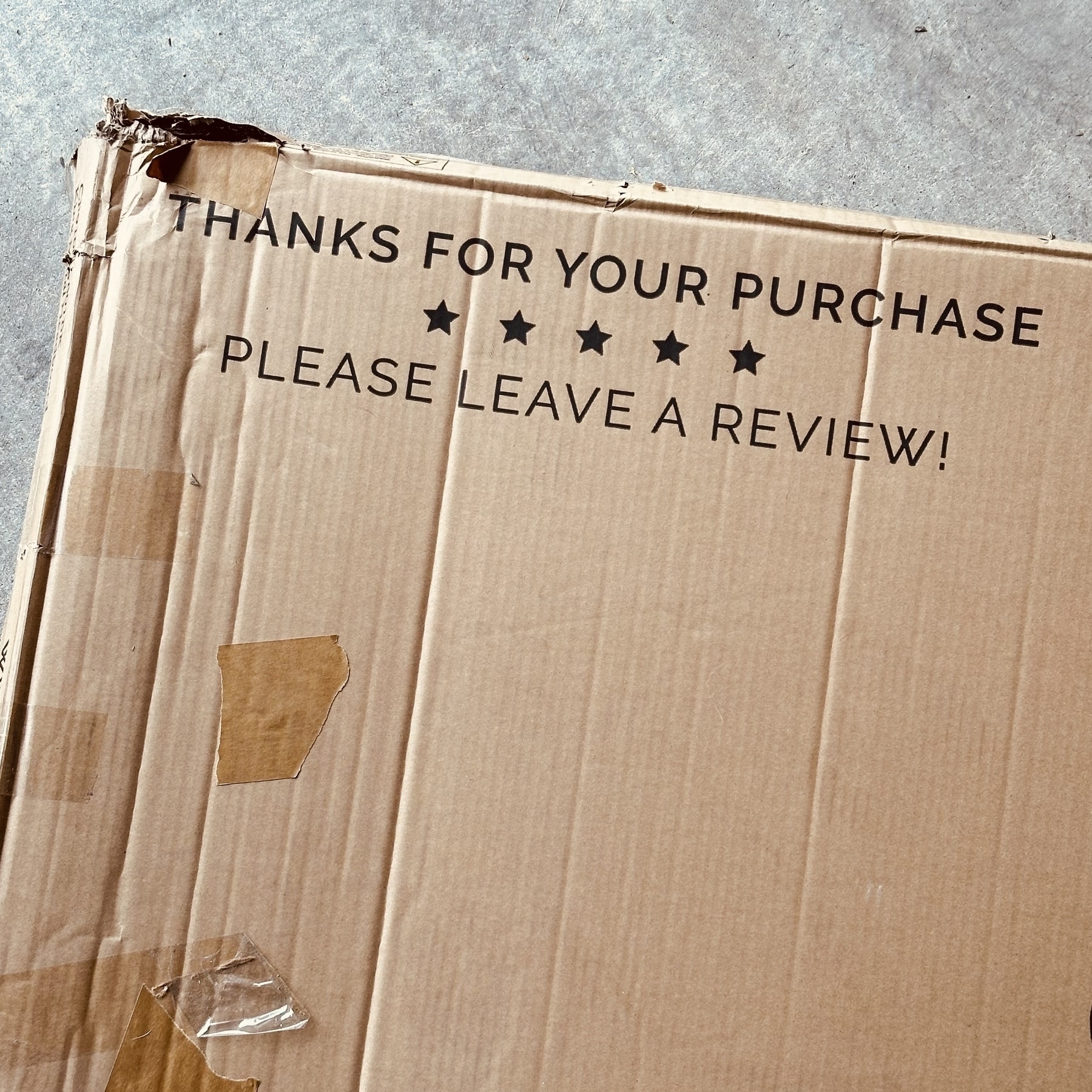 Cardboard box that says please leave a review.