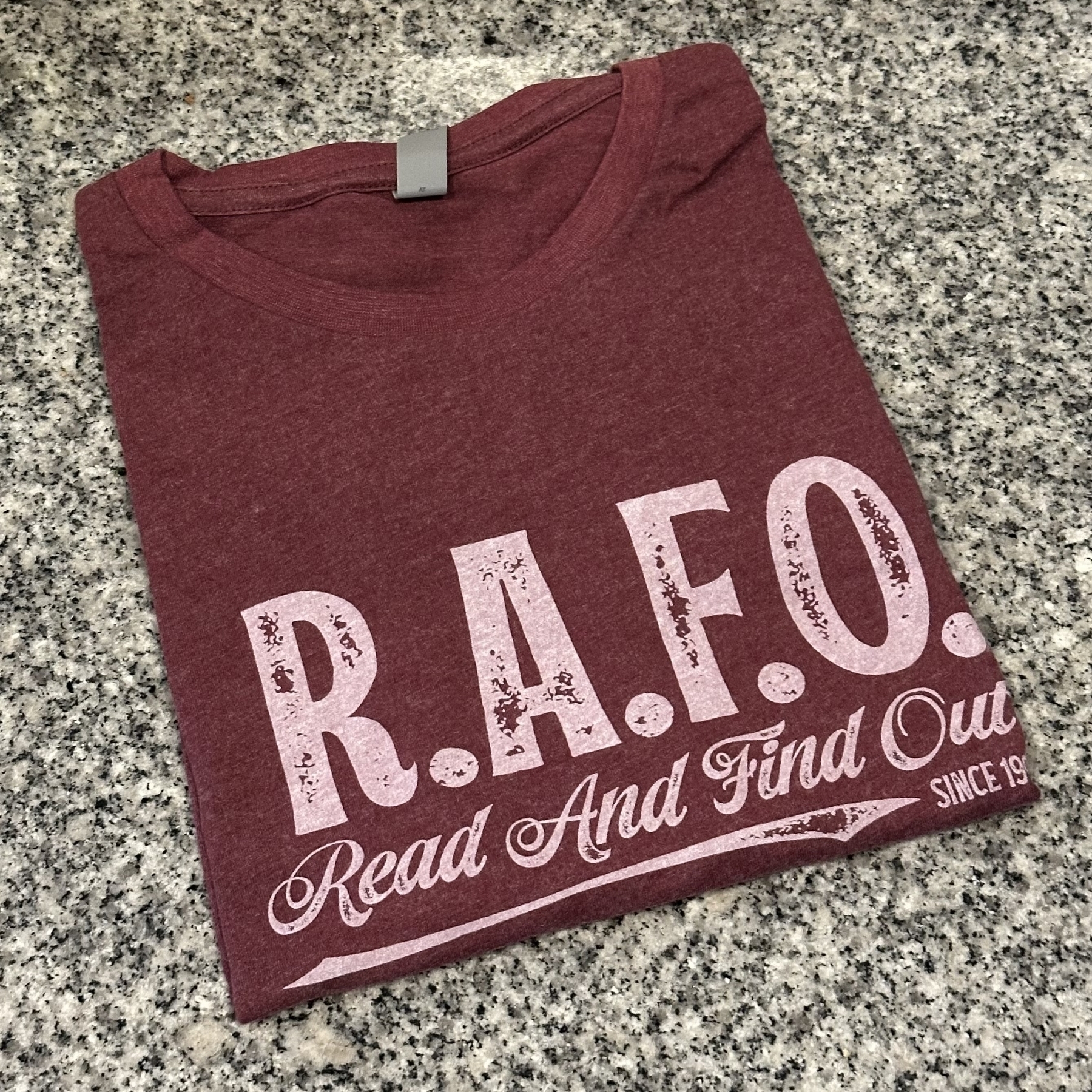 T-shirt that says RAFO on it.