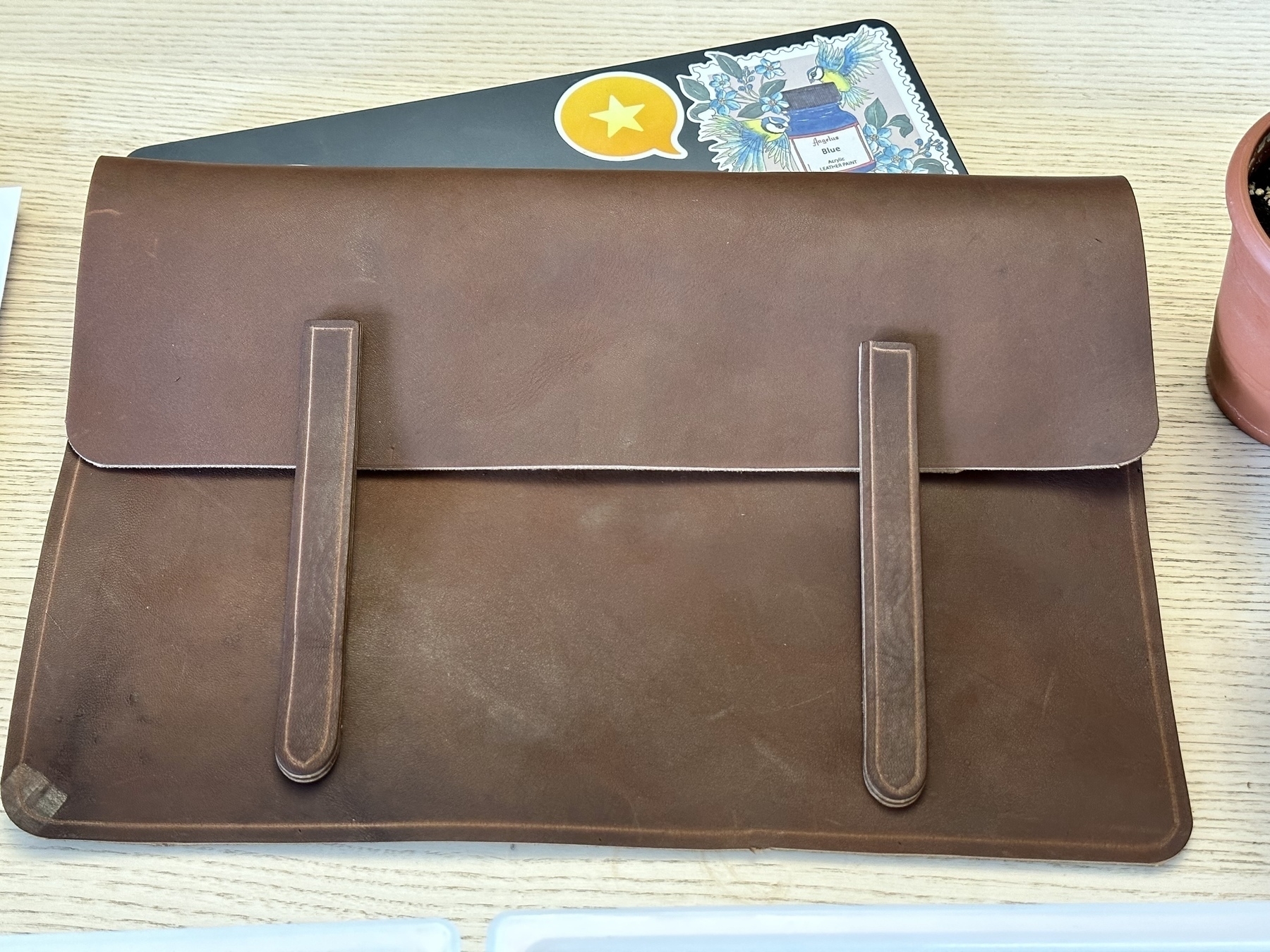Leather on top of a MacBook Air. 