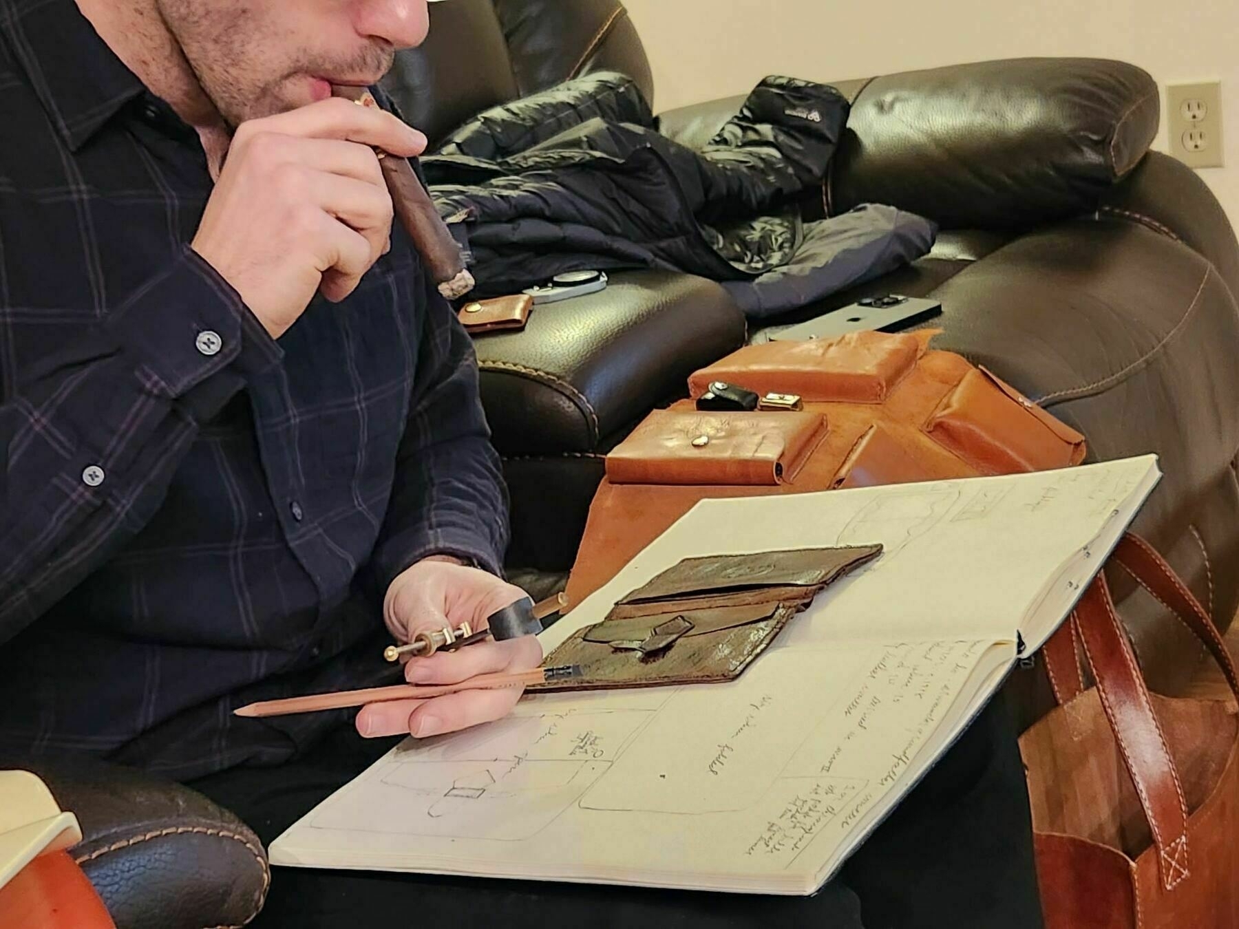 Aaron Aiken measuring and sketching the original leather wall into his notebook