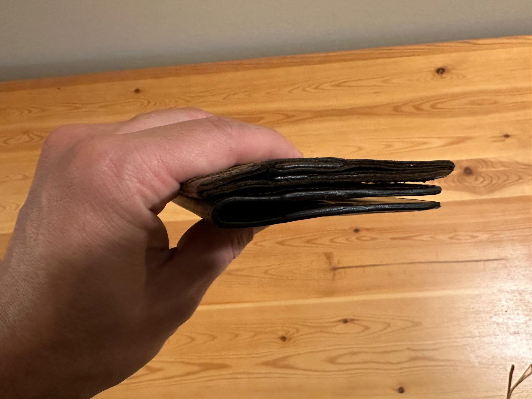 Original leather wallet and replica on top of eachother to show the similar thickness of both.