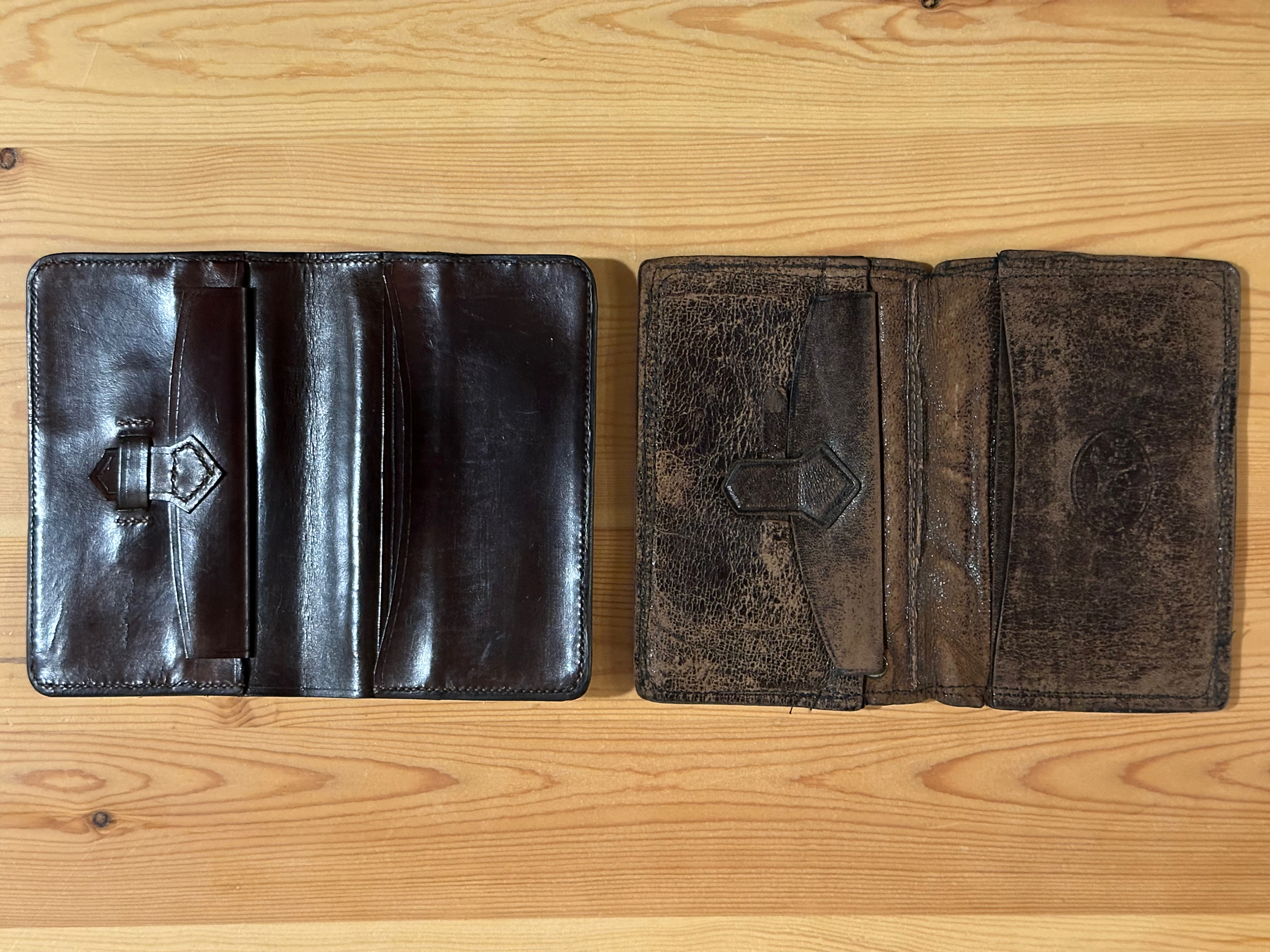 Original leather wallet and replica side by side on a table, shown open