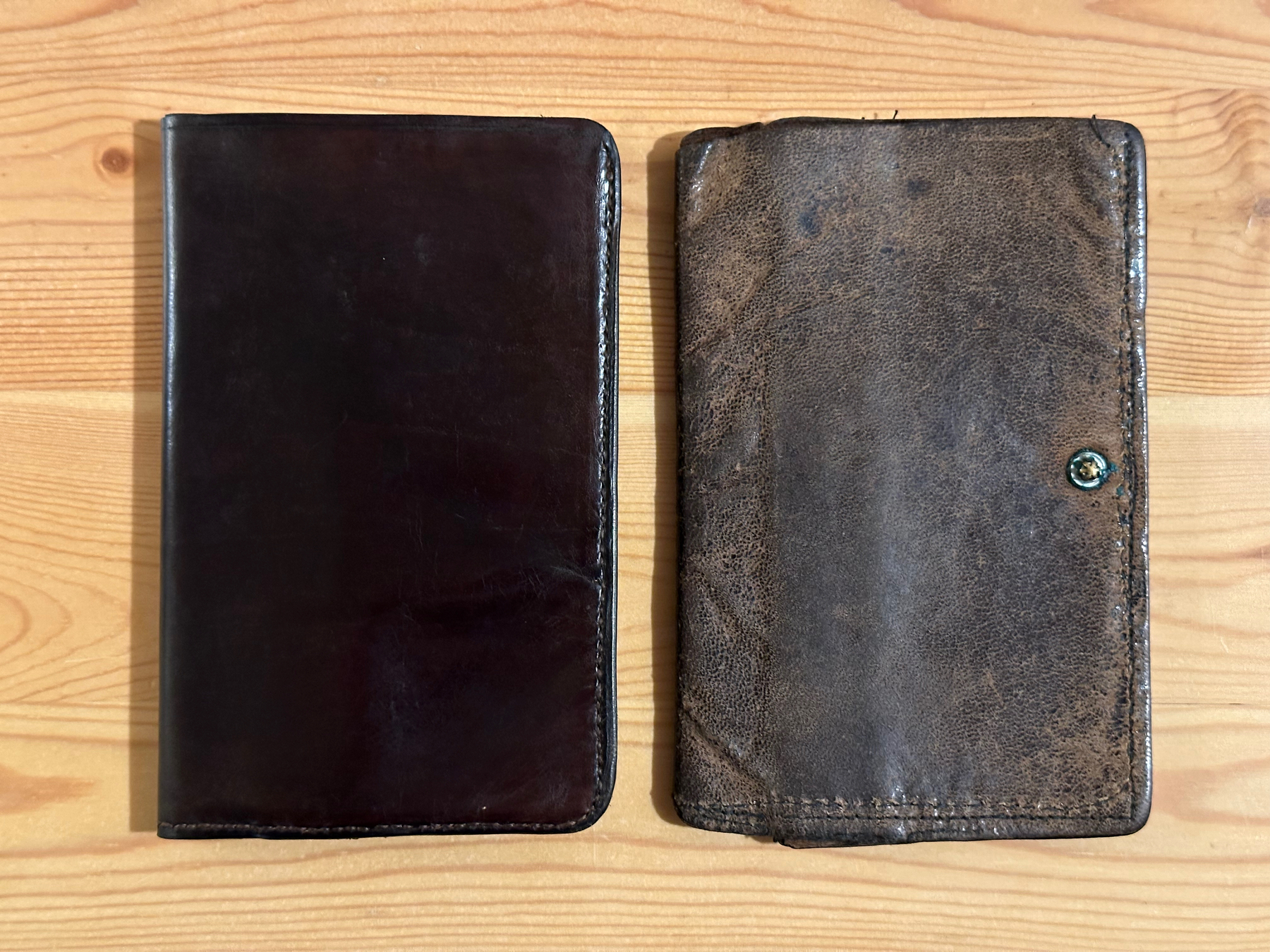 Original leather wallet and replica side by side on a table, shown closed