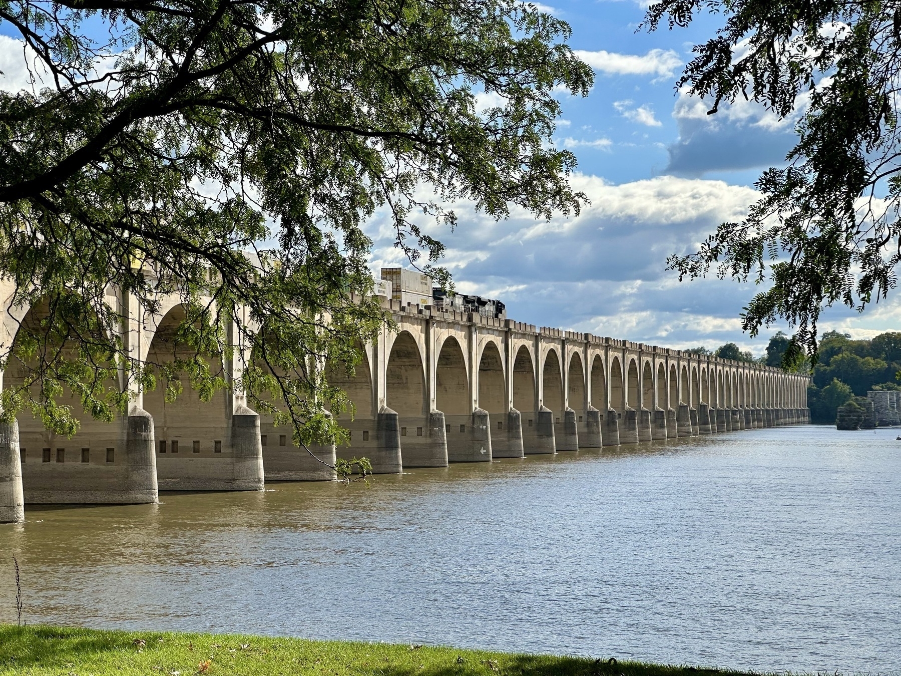 Train crossing the arch bridge over Riverfront Park and the Susquehanna River in Harrisburg Pennsylvania
