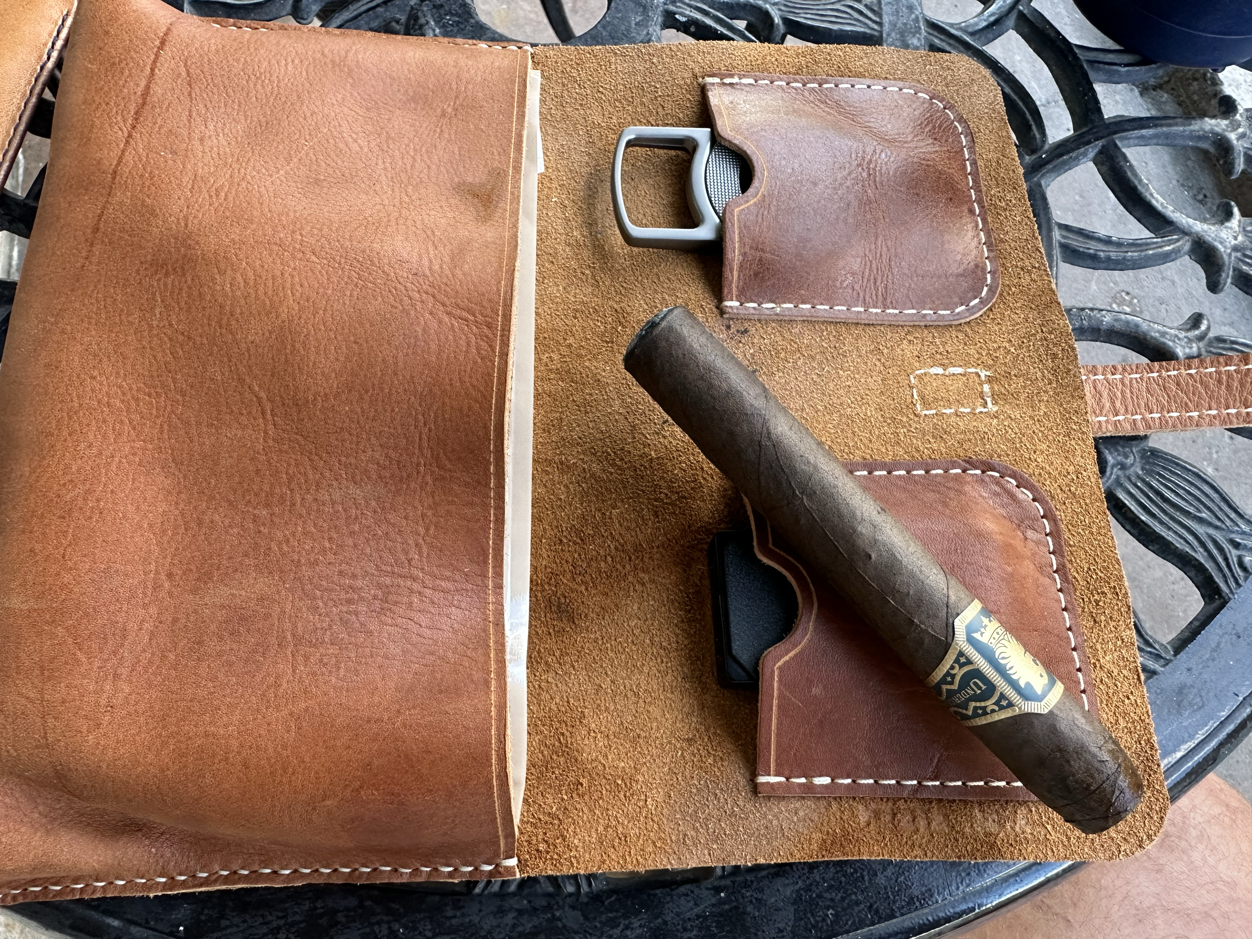 Undercrown Maduro cigar resting on top of a leather cigar case.