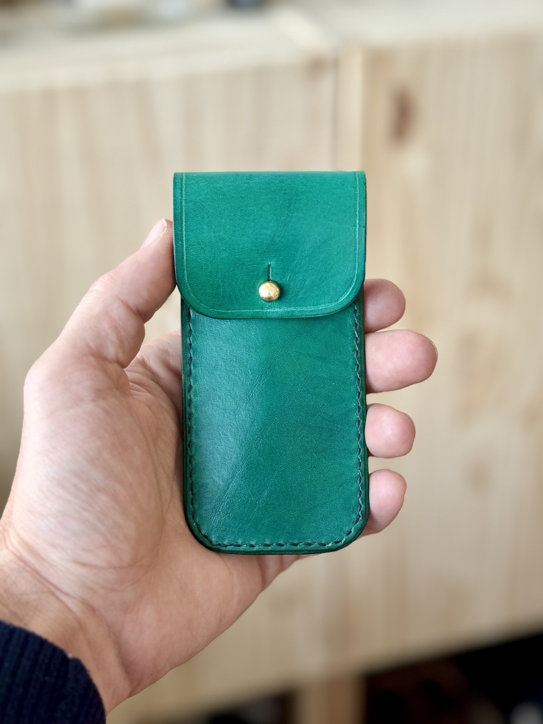 Lovely leather match pouch hand-dyed in green. Hand-stitched with black thread. Solid brass button-stud closure.