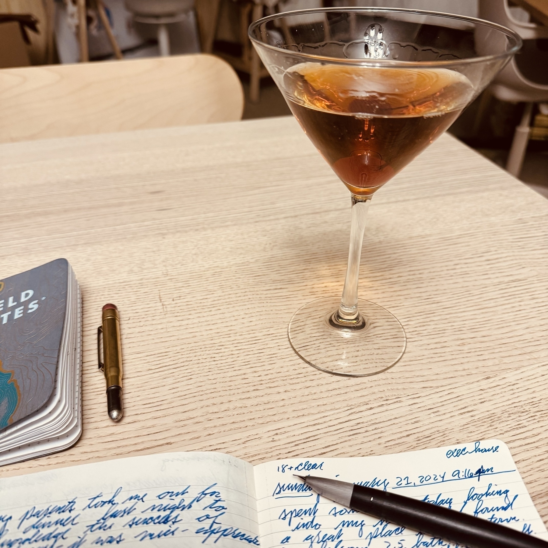 A handcrafted manhattan and Lamy 2000 (resting on a notebook) take the spotlight. 