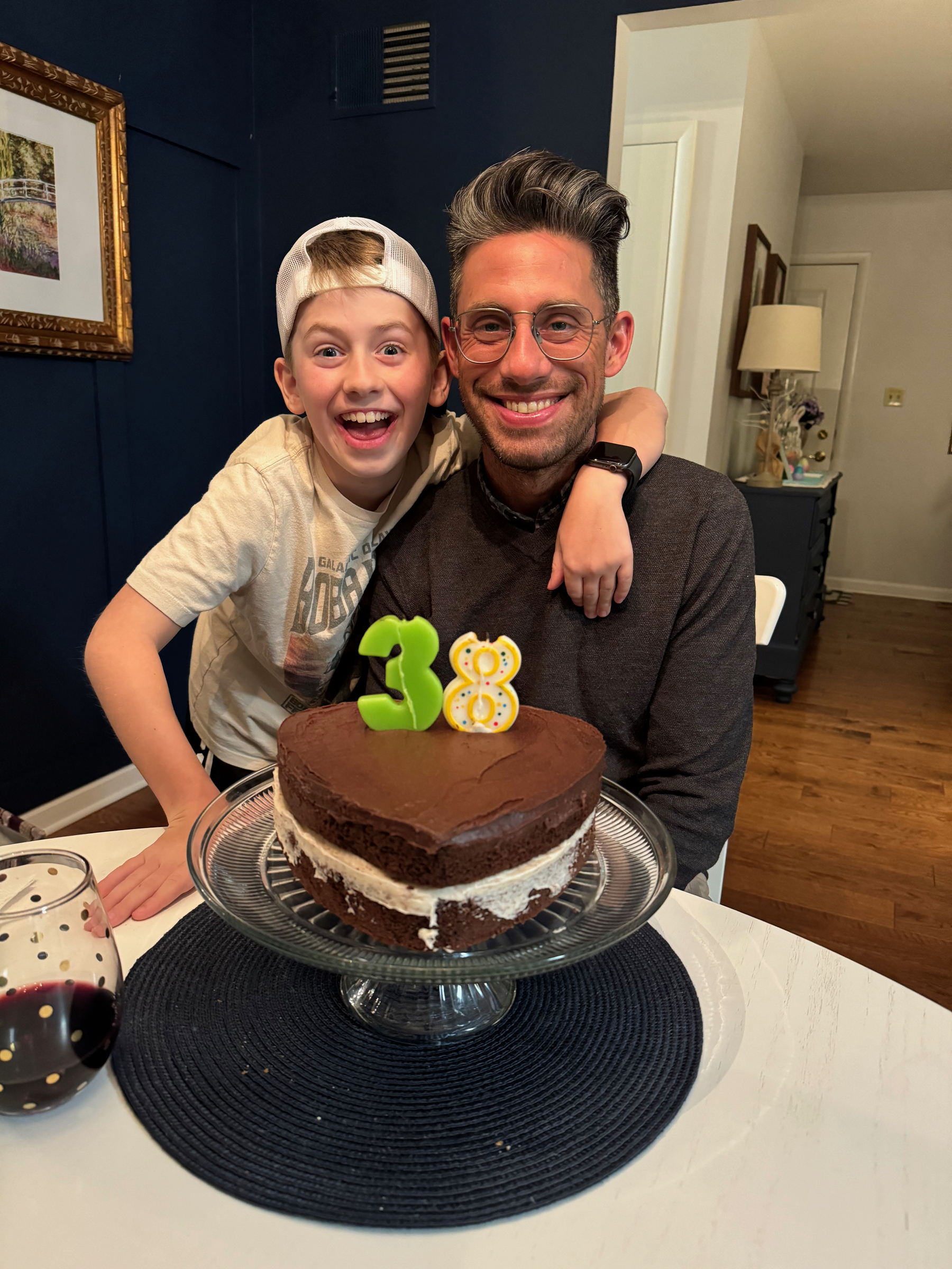 Mozzie and I with the chocolate birthday cake he helped make for me. Candles '3' and '8' on top to mark the date.