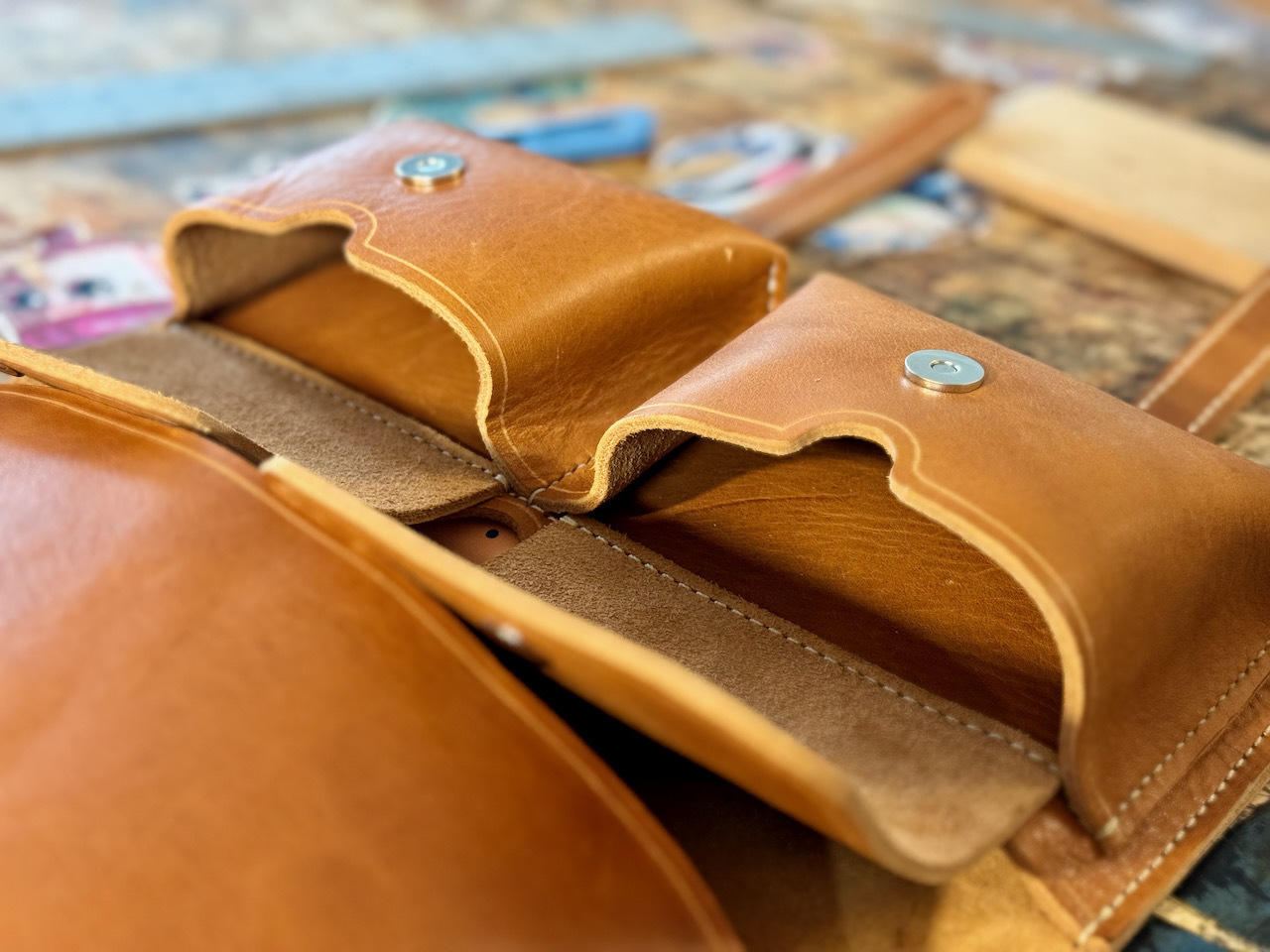 Two accessory pockets shown open on a leather cigar case