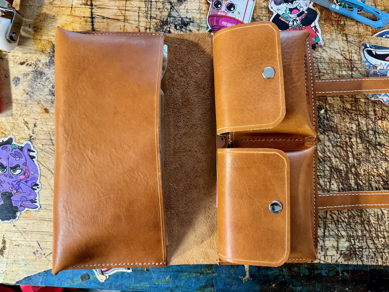 Leather cigar case shown from the top looking down. Main cigar pocket on the right, accessory pockets on the left.