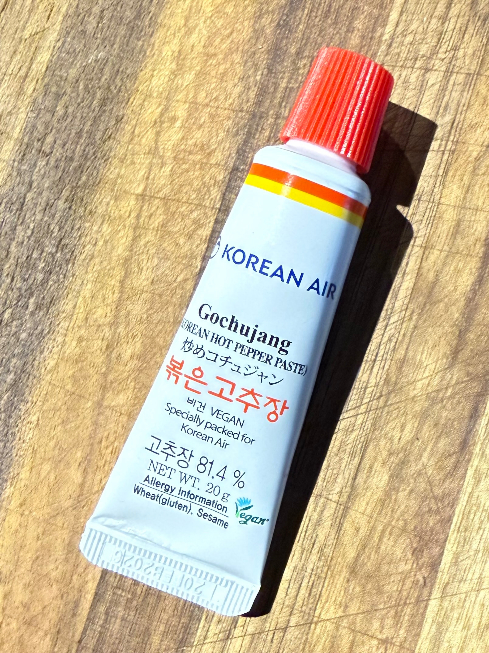 A tube labeled Gochujang Korean Hot Pepper Paste features bright red and yellow accents, emphasizing it as a vegan product with allergy information.