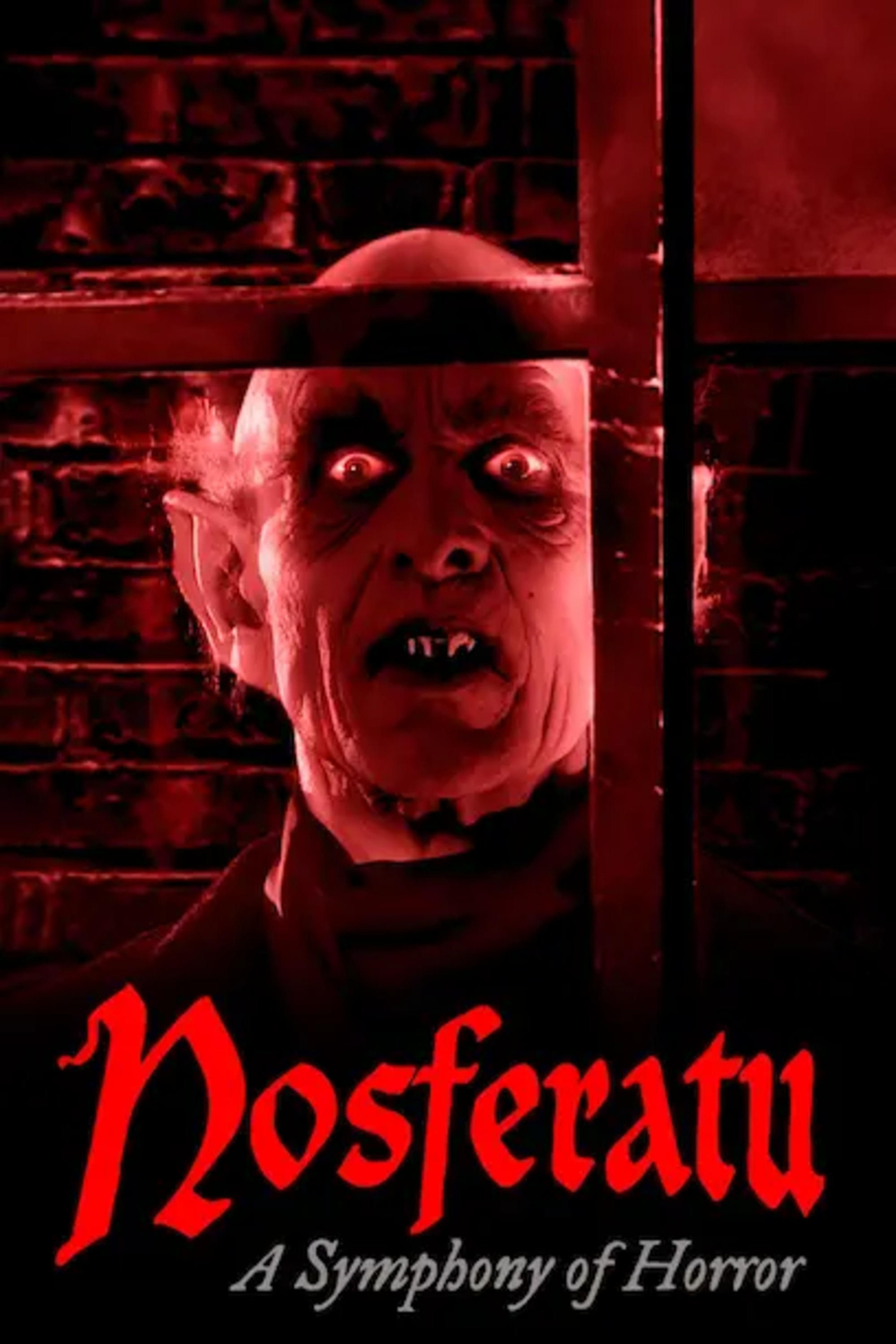 Movie poster for Nosferatu: A Symphony of Horror. The image features a terrifying vampire figure with bald head, pointed ears, sunken eyes, and sharp fangs, staring through a window with an eerie red glow. The title Nosferatu is displayed in large, blood-red Gothic font at the bottom, with the subtitle A Symphony of Horror written underneath in white script.