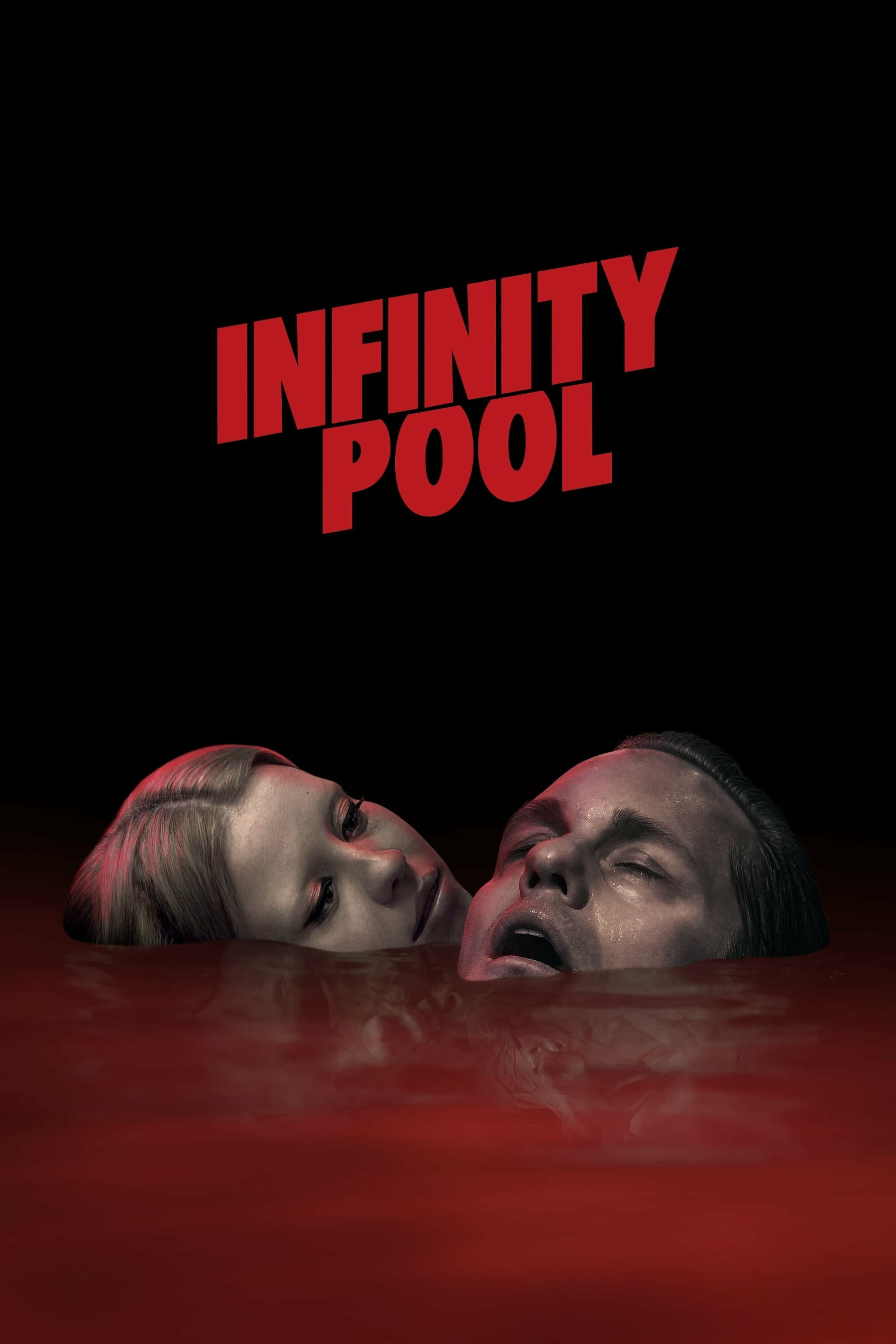 The image features the title "Infinity Pool" in bold red letters against a black background. Below, a man and a woman are depicted partially submerged in red-tinted water, with only their faces visible. The woman gazes at the man, whose eyes are closed and mouth slightly open. The atmosphere is dark and mysterious.