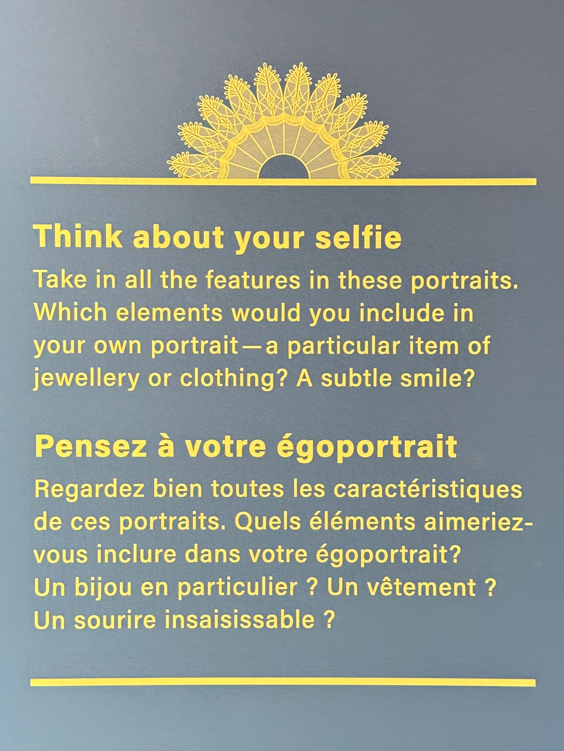 Gray background with yellow decorative pattern at the top. The text reads: "Think about your selfie. Take in all the features in these portraits. Which elements would you include in your own portrait—a particular item of jewellery or clothing? A subtle smile?" Below, in French: "Pensez à votre égoportrait. Regardez bien toutes les caractéristiques de ces portraits. Quels éléments aimeriez-vous inclure dans votre égoportrait? Un bijou en particulier? Un vêtement? Un sourire insaisissable?"