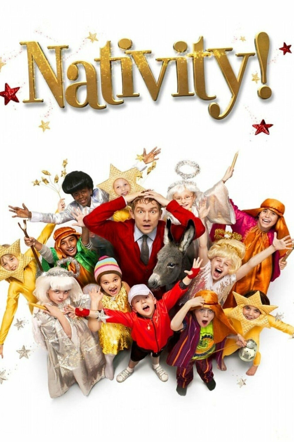 A playful, colorful group of children dressed in various festive costumes such as stars, angels, and shepherds, along with a donkey, surround a man in a red sweater who looks surprised. The children are smiling and posing energetically. The scene is lively and joyful, set against a white background with the word "Nativity!" in large gold letters above them, adorned with scattered stars.