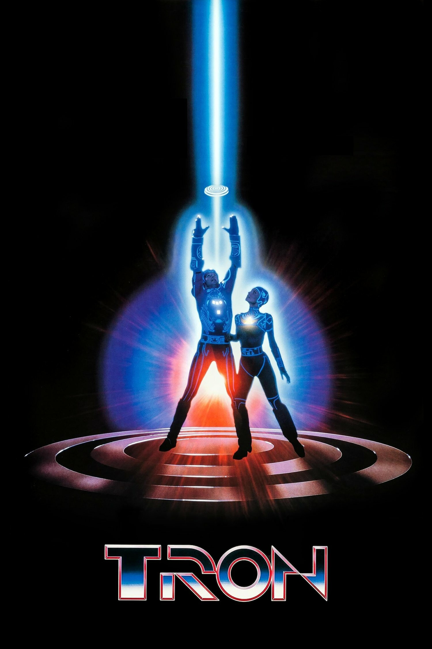 Two figures in futuristic outfits stand on a circular platform, reaching towards a disc emitting a beam of blue light. The scene is surrounded by a dark background with a blue and red glow. The word "TRON" is displayed at the bottom.