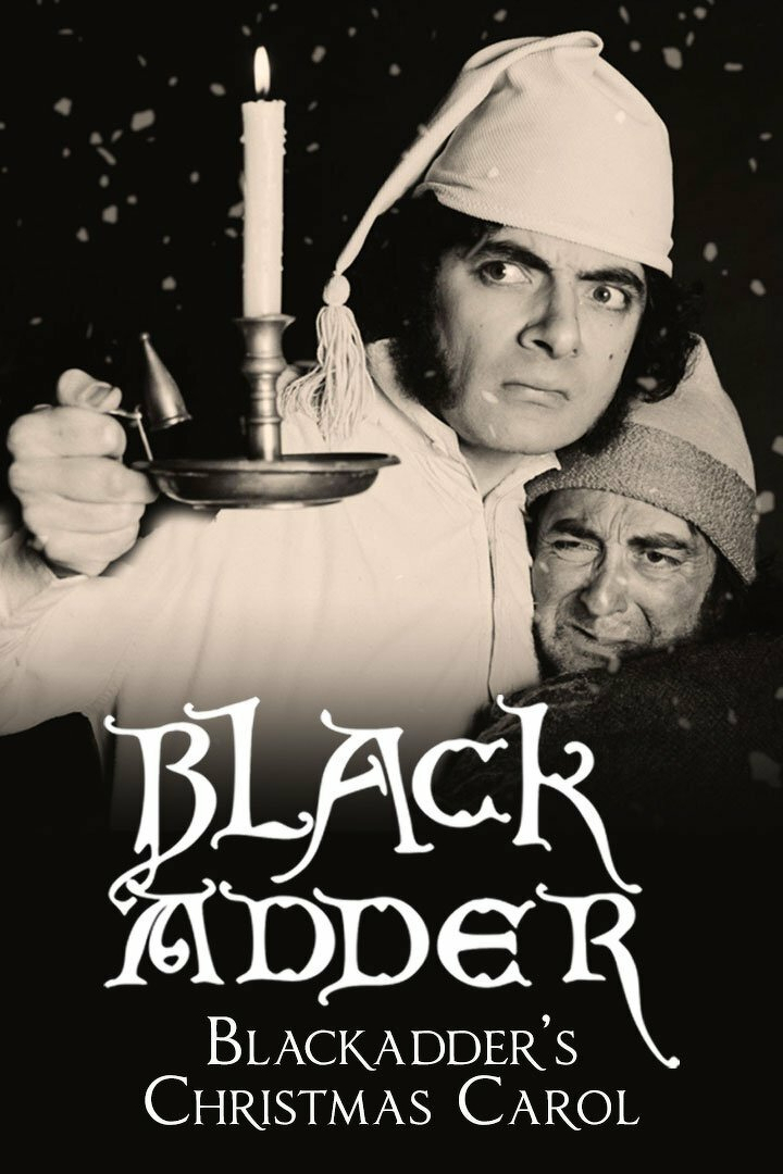 Black and white image of two men in winter attire. One is wearing a nightcap and holding a lit candle with a serious expression. The other is huddled close, wearing a knitted cap. Snowflakes are visible in the scene. The text "Blackadder's Christmas Carol" is written at the bottom.