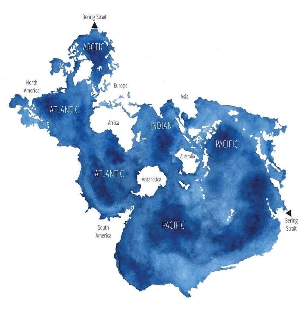 Watercolor map illustrating ocean and continent names with continents as blue bodies of water and oceans as white land masses. North America, South America, Europe, Africa, Asia, Australia, and Antarctica are labeled, surrounded by the Arctic, Atlantic, Indian, and Pacific Oceans. The Bering Strait is labeled on opposite sides of the map.
