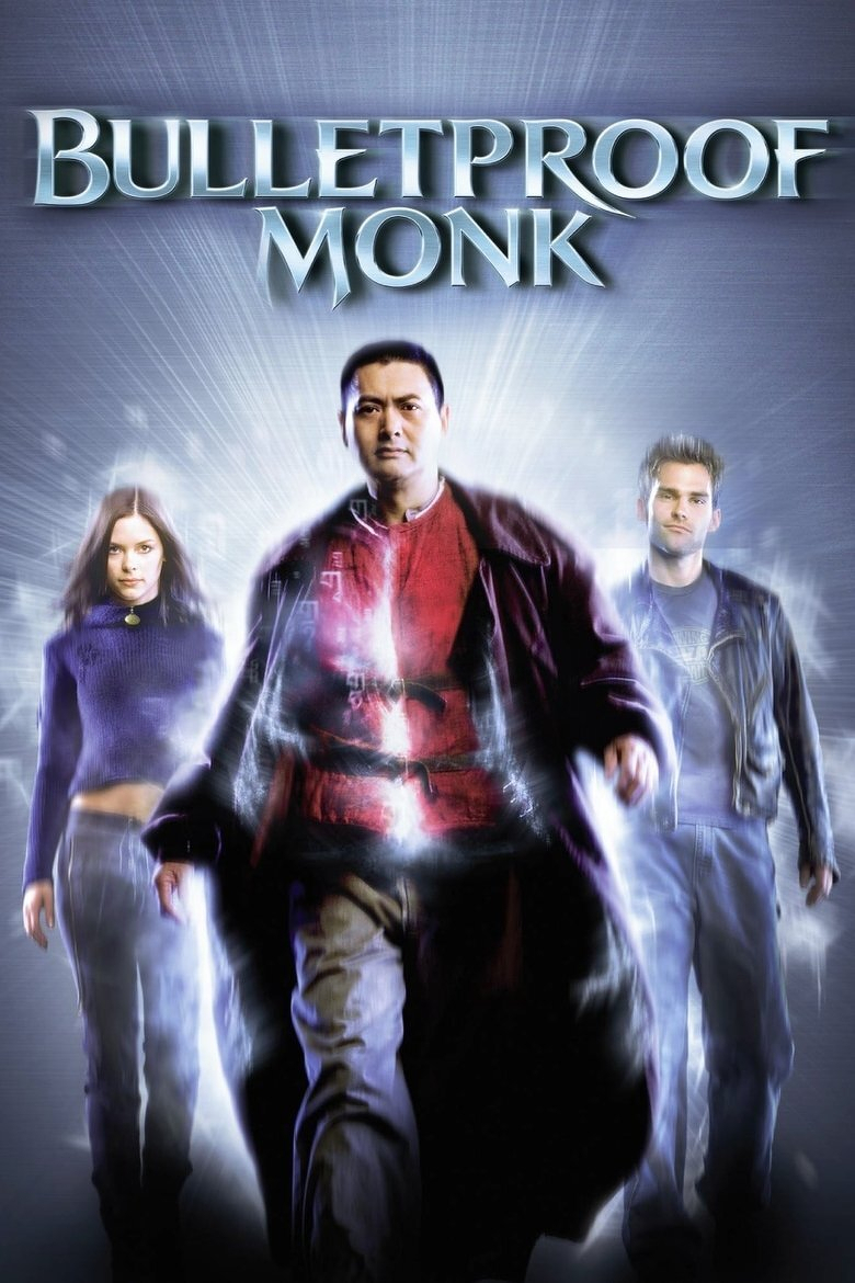 A movie poster featuring three characters walking forward with a glowing, radiant energy surrounding them. In the centre is a man wearing a red robe under a dark coat, exuding confidence and power, with mystical light emanating from his chest. To his left is a young woman with long brown hair, wearing a dark purple cropped sweater and jeans, and to his right is a young man with short hair in a leather jacket and jeans. The background is a burst of white and blue light, creating a dynamic, supernatural effect. At the top, large metallic letters spell out “BULLETPROOF MONK.”