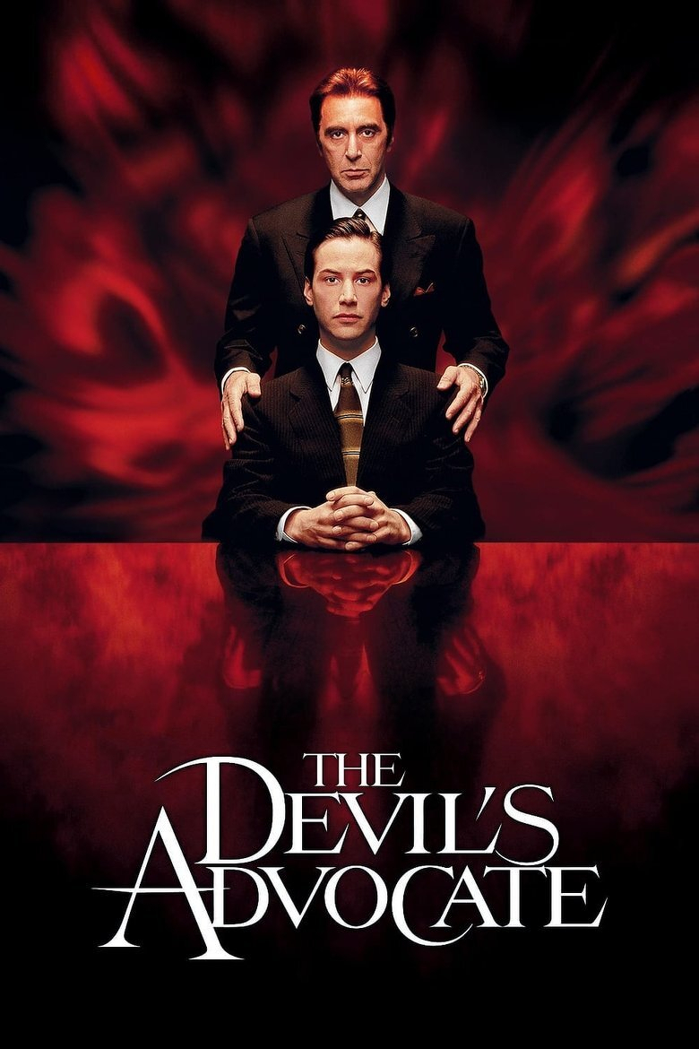 A movie poster with a dark red, swirling background that looks like smoke or flames. A man with slicked-back reddish-brown hair and a serious expression stands behind a seated younger man in a dark pinstriped suit, white shirt, and gold-striped tie. The standing man wears a dark double-breasted suit with a patterned pocket square and rests both hands on the seated man's shoulders. The seated man sits upright with his hands clasped in front of him and gazes straight ahead. Below them, the red surface reflects the figures like polished glass. The bottom of the poster has large white serif text reading "THE DEVIL'S ADVOCATE," with oversized, stylized letters "A" and "D."