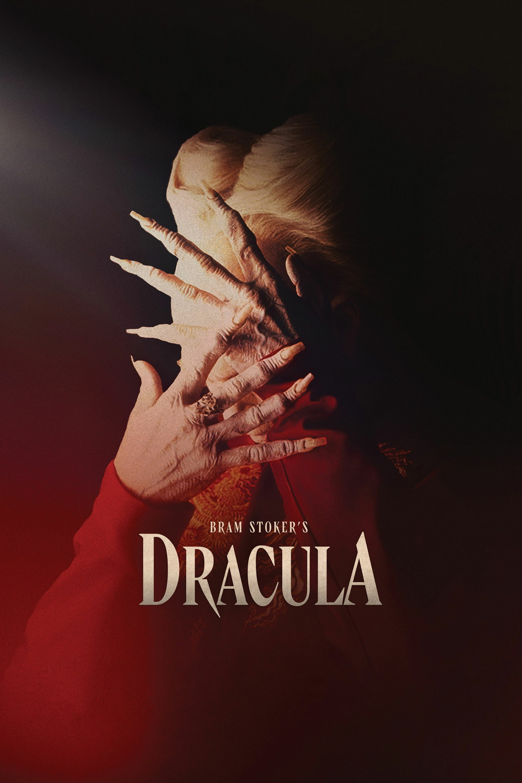 An eerie image of a person with a dramatic, theatrical appearance, wearing a red garment. Their face is obscured by a wrinkled, pale hand with elongated fingers and sharp nails, suggesting an otherworldly or supernatural theme. The background is dark, with a gradient of red on the left and black on the right. Text at the bottom reads "Bram Stoker's Dracula" in bold, gothic-style lettering.