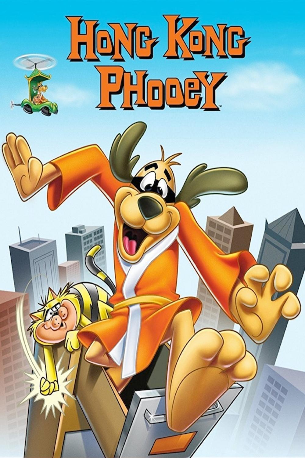 An animated illustration of the character Hong Kong Phooey jumping energetically from an office filing cabinet drawer in a cityscape. He is a brown dog wearing an orange karate robe with a yellow belt, smiling widely with one paw in the air. Beside him, a chubby yellow-and-black striped cat is being pulled along, looking startled as it punches the air. In the background, several tall grey and brown city buildings rise against a blue sky with light clouds. A small green car with helicopter blades flies in the upper left corner, piloted by a character wearing orange. At the top of the image, large orange text with black outlines reads “HONG KONG PHOOEY.”