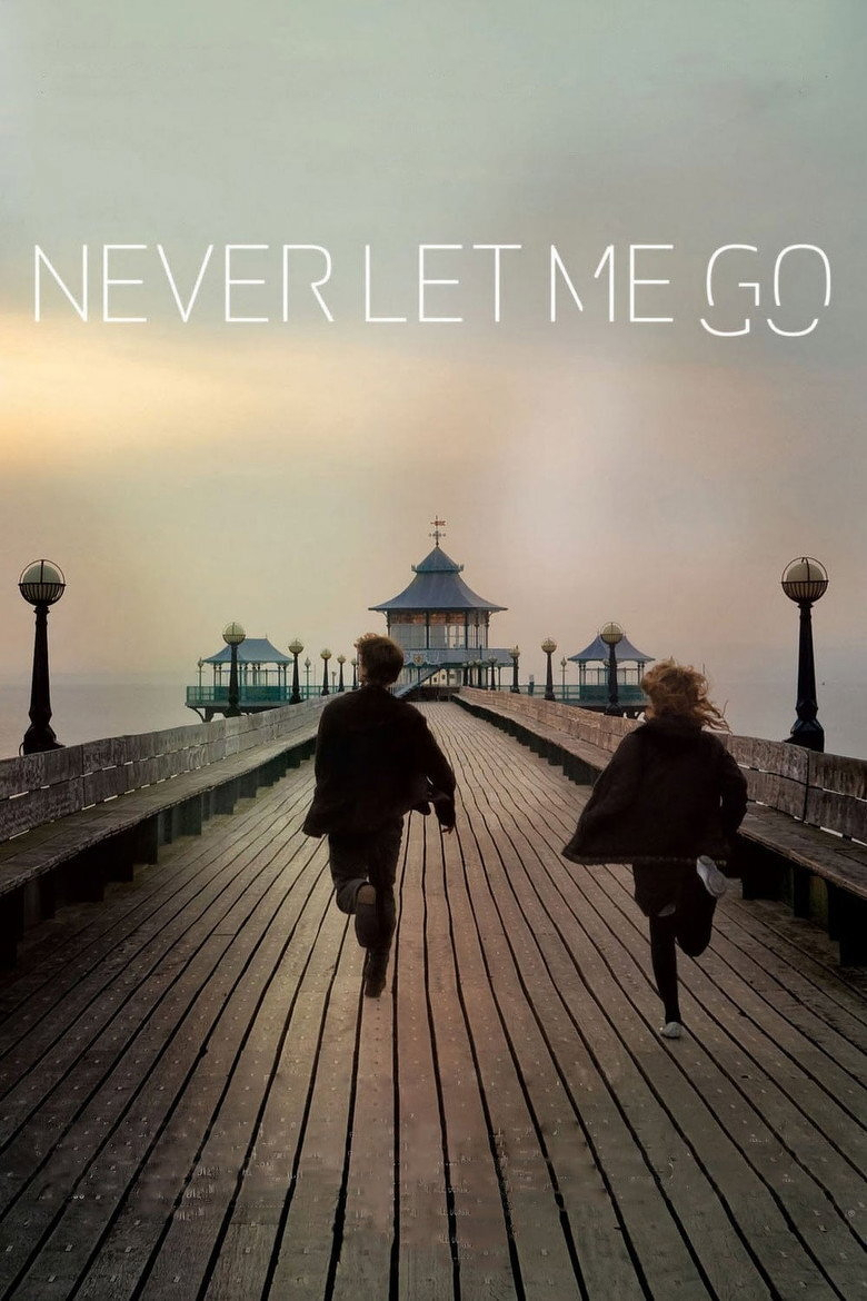 Two people, a man and a woman, are running hand-in-hand down a long wooden pier toward a pavilion with a blue roof, surrounded by multiple lampposts. The sky is overcast with soft, muted tones of sunrise or sunset. The water on either side of the pier appears calm and misty, blending into the horizon. At the top of the image, the words “NEVER LET ME GO” are written in large, thin, white, modern font.
