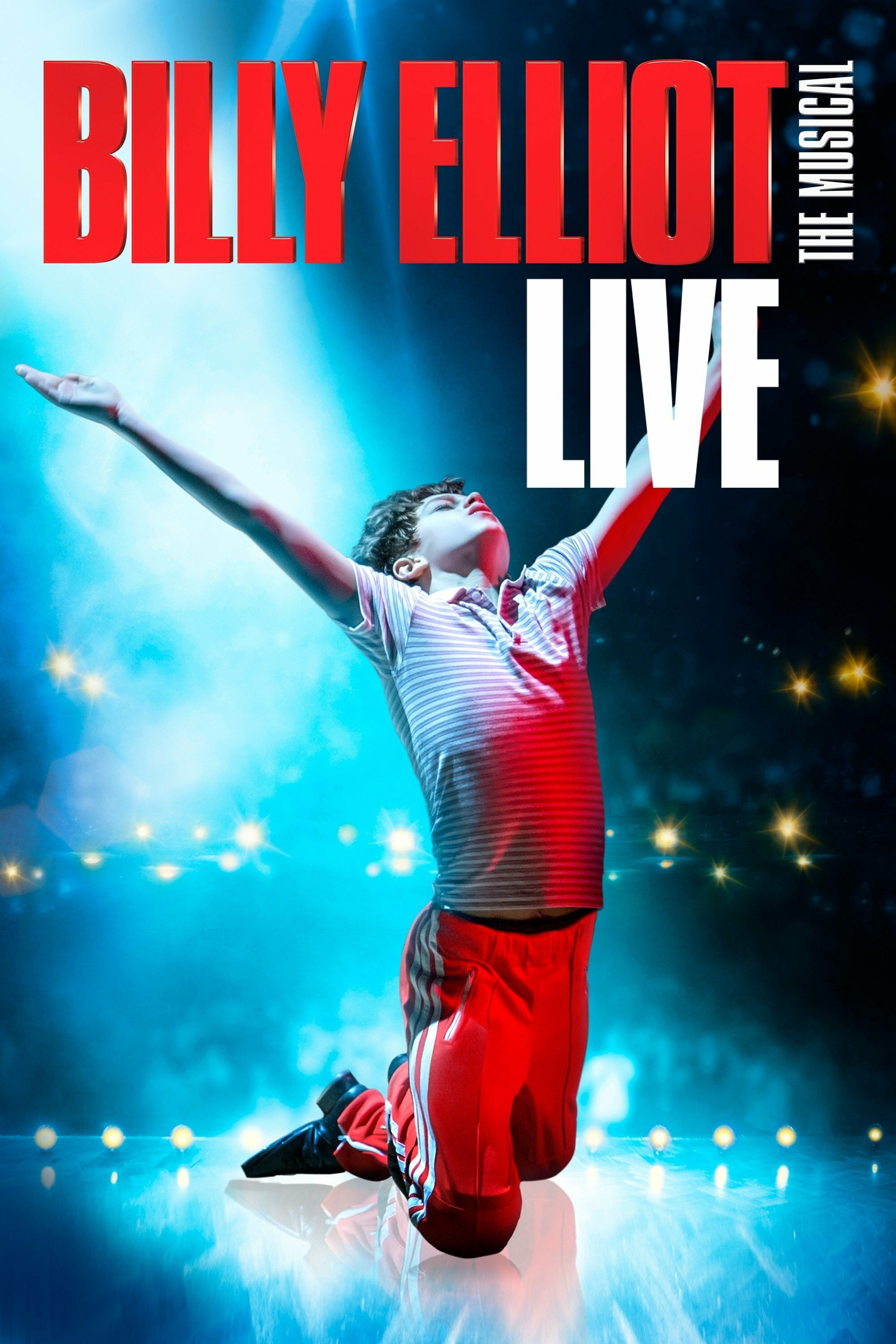 Poster for "Billy Elliot: The Musical Live" featuring a young boy kneeling on stage with arms outstretched and head tilted back. He wears a striped shirt and red pants. The background is illuminated with blue lighting and star-like effects, with bold red and white text above.