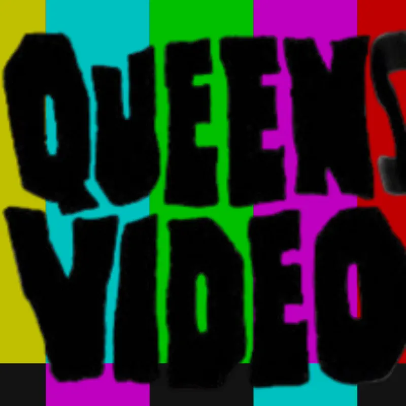 A brightly coloured image with a background of vertical stripes in yellow, cyan, green, magenta, red, and black, resembling a TV test pattern. Overlaid in large, bold, black, jagged letters are the words “QUEENS VIDEO,” with “QUEENS” on the top row and “VIDEO” on the bottom row. The text is slightly irregular and uneven, giving it a rough, hand-drawn appearance. The multicoloured stripes create a vibrant and contrasting backdrop for the bold black text.