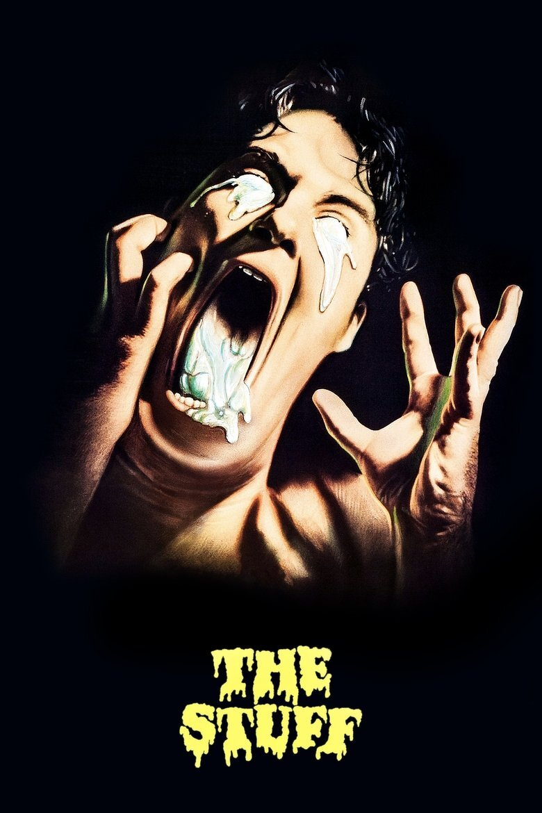 A horror-themed image shows a person screaming in agony with their mouth wide open and white, gooey substance oozing out of their mouth and eyes. Their hands are raised near their face in a gesture of terror or pain, and their expression is one of extreme distress. The background is completely black, emphasizing the figure. At the bottom of the image, the words “THE STUFF” appear in large, dripping yellow letters resembling slime or melting goo.