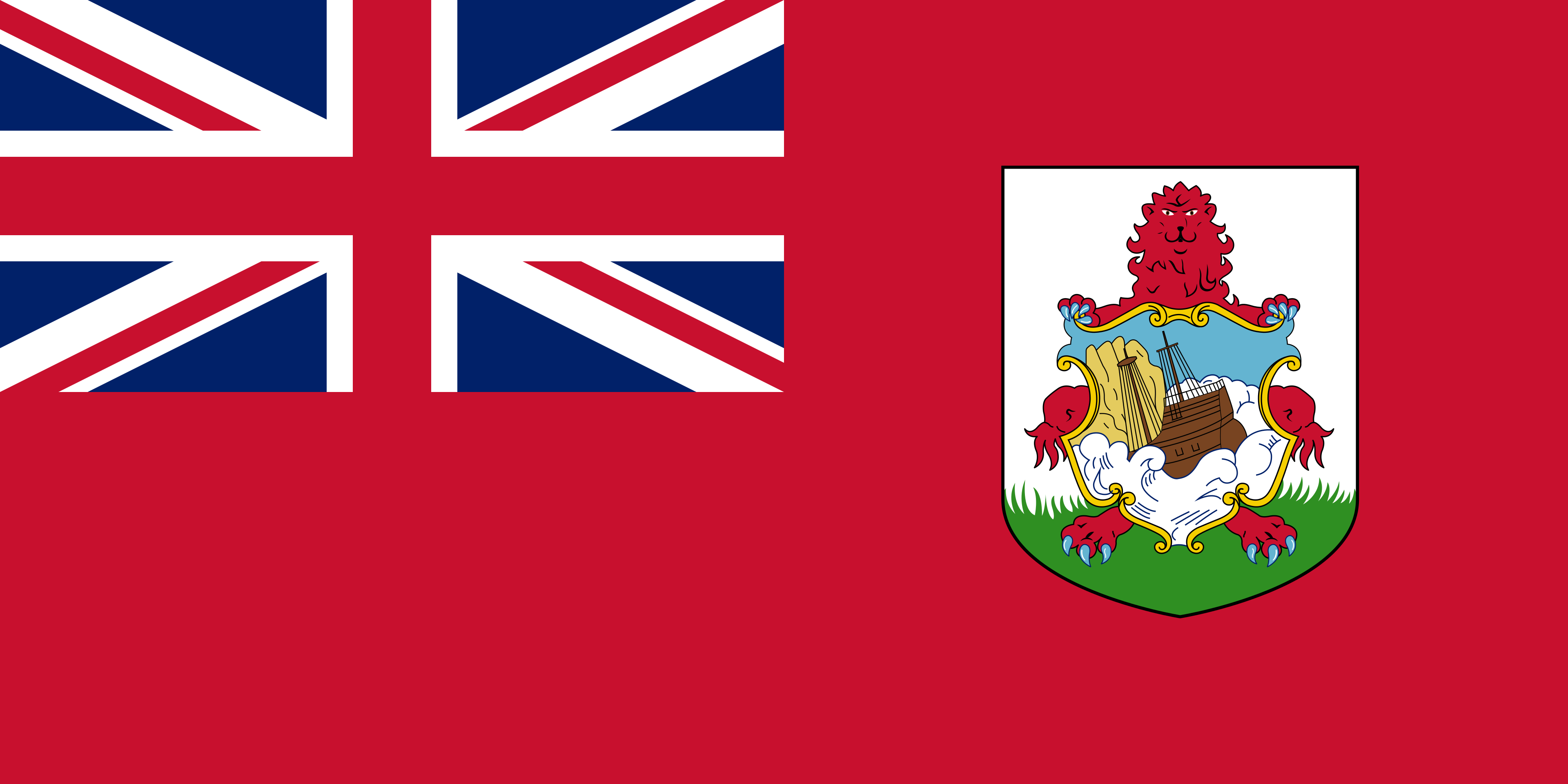 A red flag featuring the Union Jack in the top left corner and a white shield on the right side. The shield displays a red lion holding a smaller shield that depicts a wooden ship wrecked on rocks with blue waves and clouds around it. The red lion stands above the shield on a grassy green base. The design combines maritime elements with the heraldic lion motif.