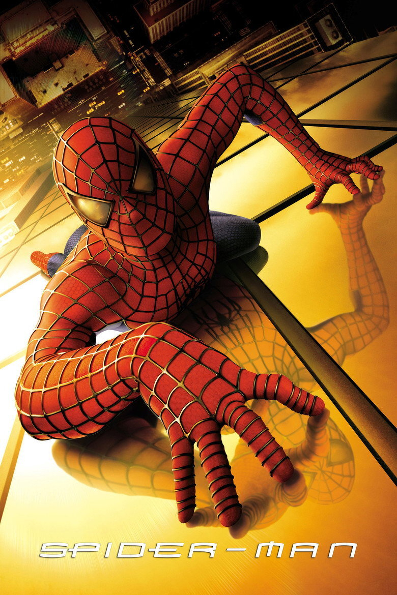 Spider-Man is crawling on the side of a golden glass skyscraper, with his right hand extended toward the viewer and his left hand gripping the surface. His iconic red and blue suit with black web patterns is clearly visible, and his reflective white eye lenses catch the city lights. The city skyline is tilted in the background, with illuminated buildings and streets. His reflection is visible on the shiny glass surface beneath him. At the bottom of the image, the word “SPIDER-MAN” is written in sleek white capital letters.