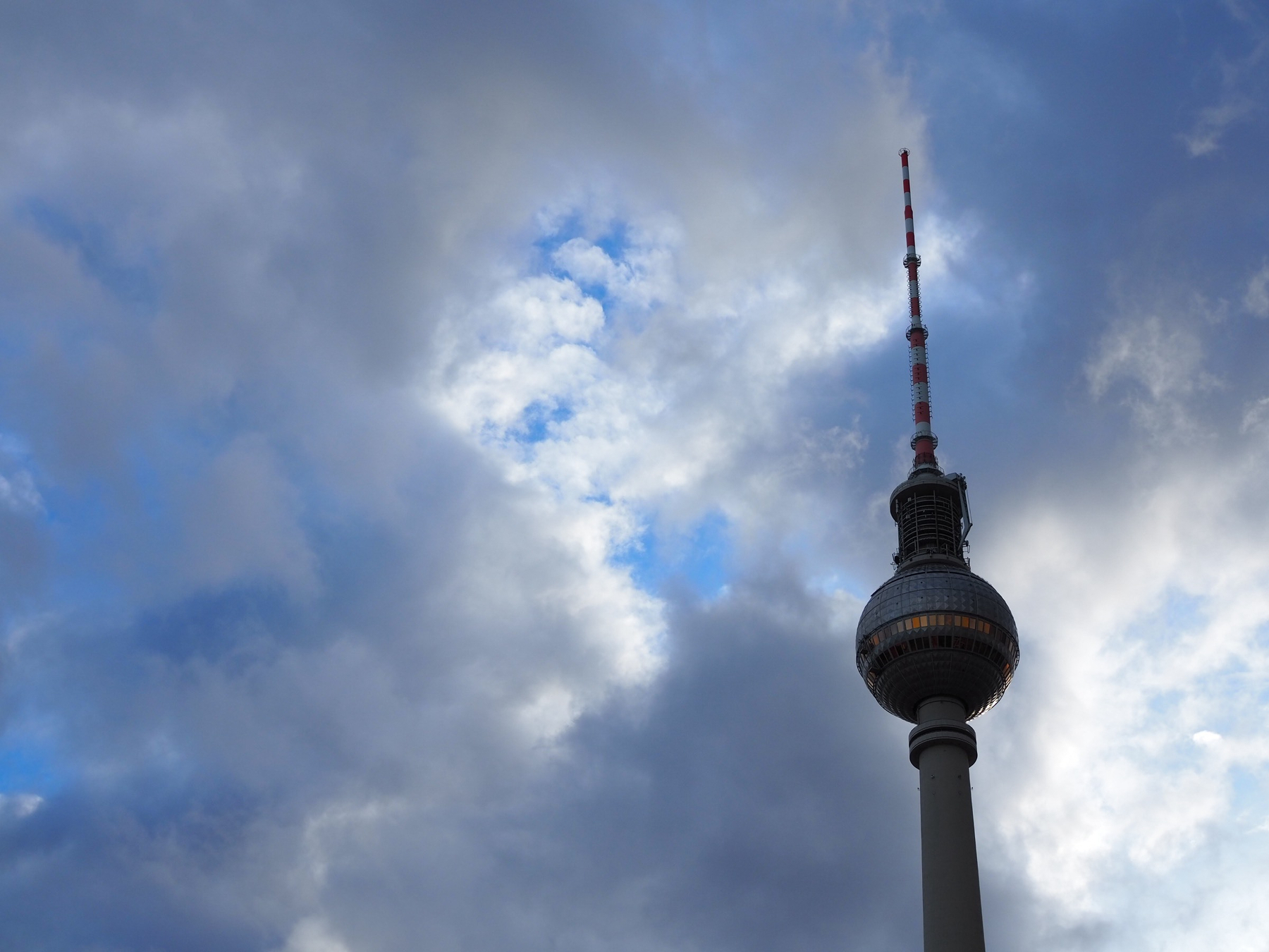 Berlin TV tower against the blue sky, with clouds. 