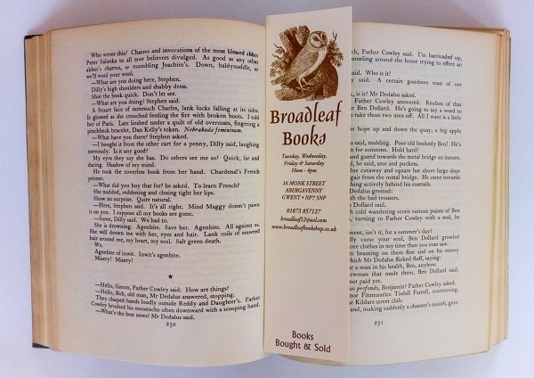 A 'Broadleaf Books' bookmark resting in an open copy of James Joyce's 'Ulysses'.