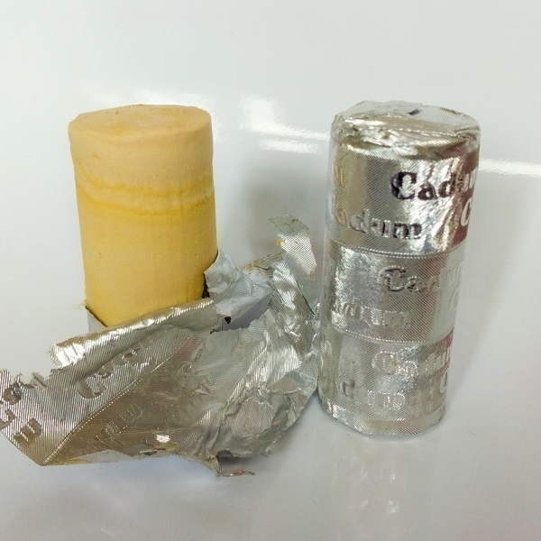 Two 'Cadum' brand vintage French shaving soaps, one partly-unwrapped.