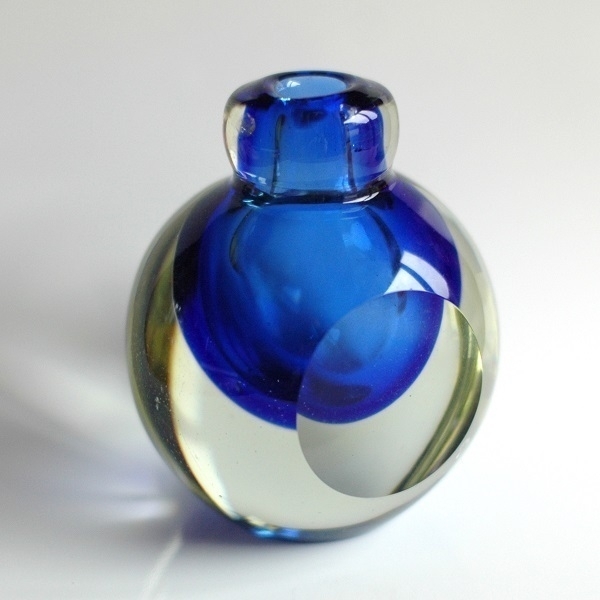 A small blue (and clear) ornamental glass vase.