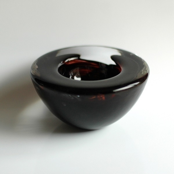 A small brown (and clear) ornamental Kosta Boda glass bowl.