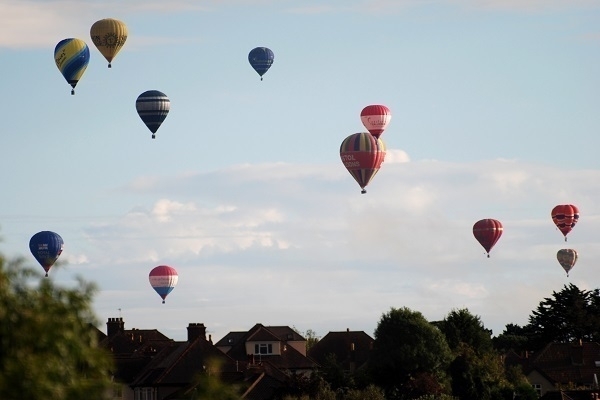 Hot-air balloons floating over suburban Bristol.