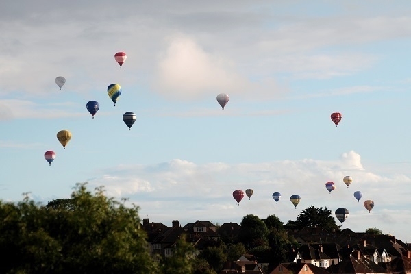 Hot-air balloons floating over suburban Bristol.