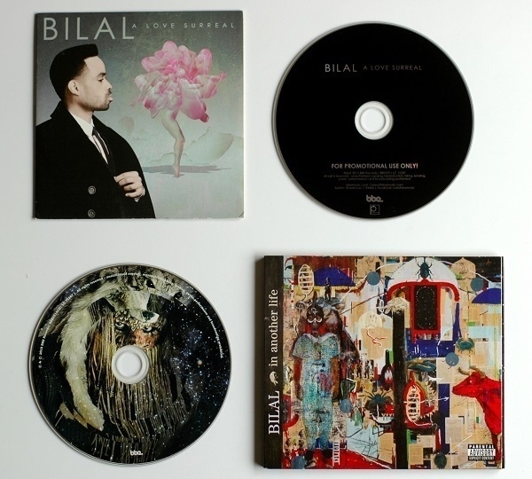 CD copies of the albums 'A Love Surreal' and 'In Another Life' by Bilal'.