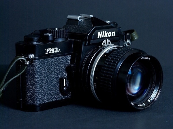 A Nikon FM3a 35mm film camera with an 85mm Nikkor lens.