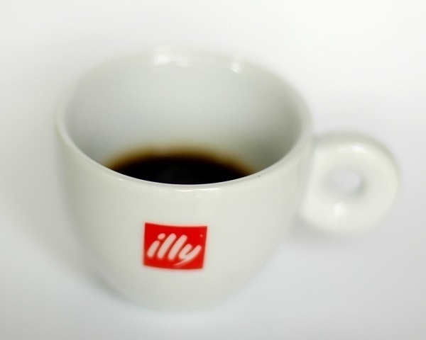 Some 'Illy'-brand espresso in an 'Illy'-branded espresso cup.