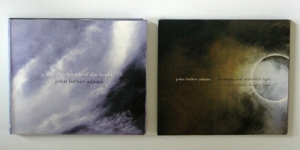 CD copies of the albums 'sila: the breath of the world' and 'darkness and scattered light' both featuring music composed by John Luther Adams.
