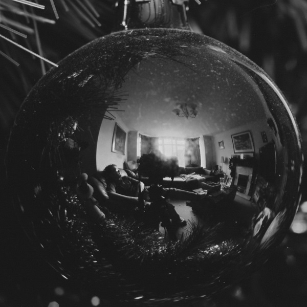 A black-and-white 'Self-Portrait in a Christmas-Tree Bauble'.