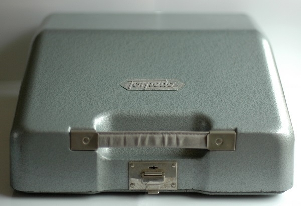 A metal carrying case for a '50s Torpedo-brand typewriter.