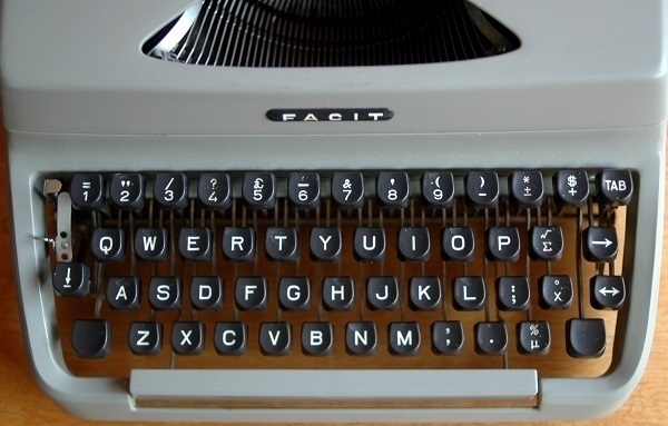 The keyboard of a 1965 Facit TP-1 typewriter, including a few mathematical symbols.